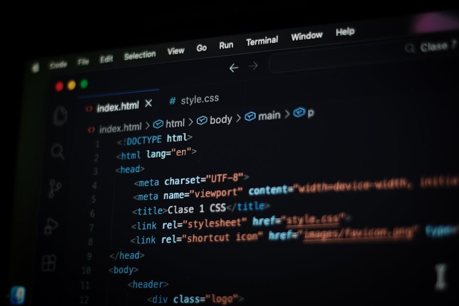 Close-up view of a computer screen showing a code editor with lines of programming code in multiple colours on the right side, indicating a technical or software development environment. On the left s